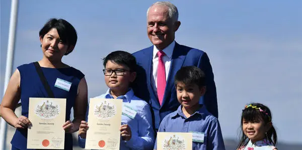 Prime Minister Malcolm Turnbull poses with new Australian citizens at an Australia Day Citizenship Ceremony and Flag Raising event in Canberra 2018 (Photo SBS)