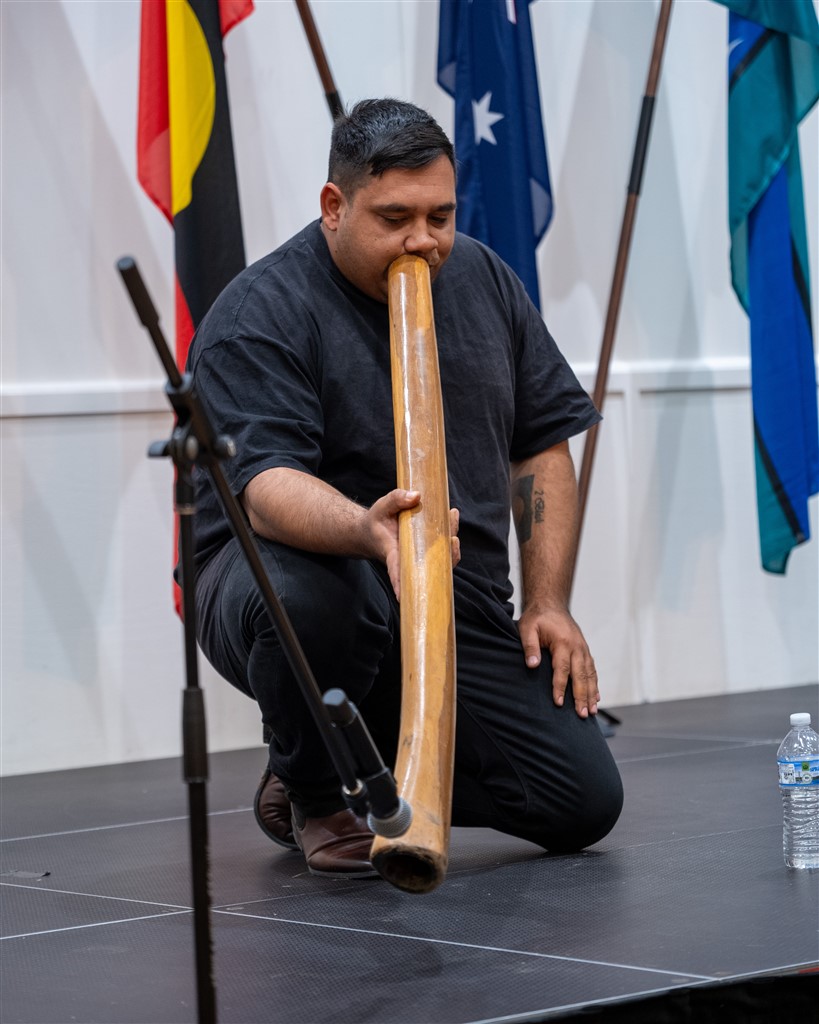 Aboriginal didgeridoo player performing during the Logan City Council citizenship ceremony. Photo: Home Affairs.